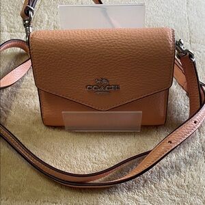Coach Peach Pebbled Leather Wallet
With Removable Adjustable Strap